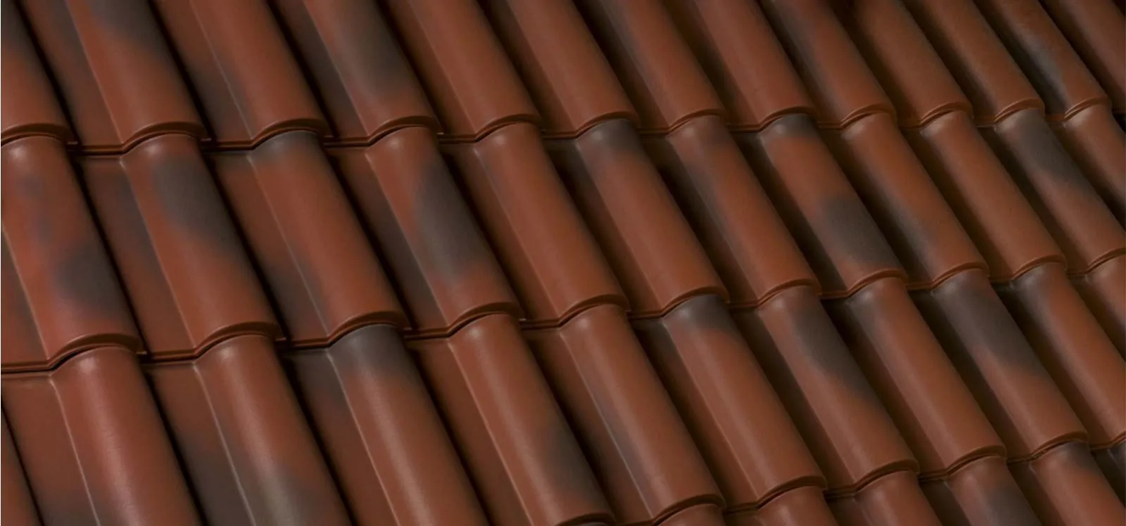 Close view of a Tecno barrel clay roof tile in Rustic Red, showing the interlock and the fired surface