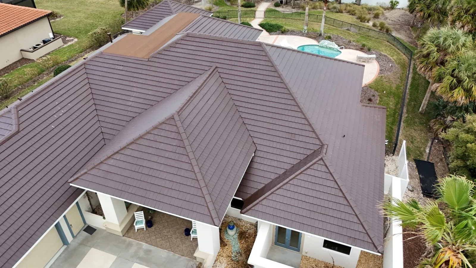 Plasma flat clay roof tile in Brown on a finished waterfront house