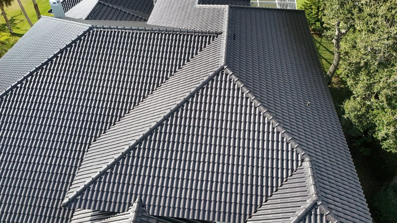 Tecno barrel clay roof tile in Titanium on a finished house