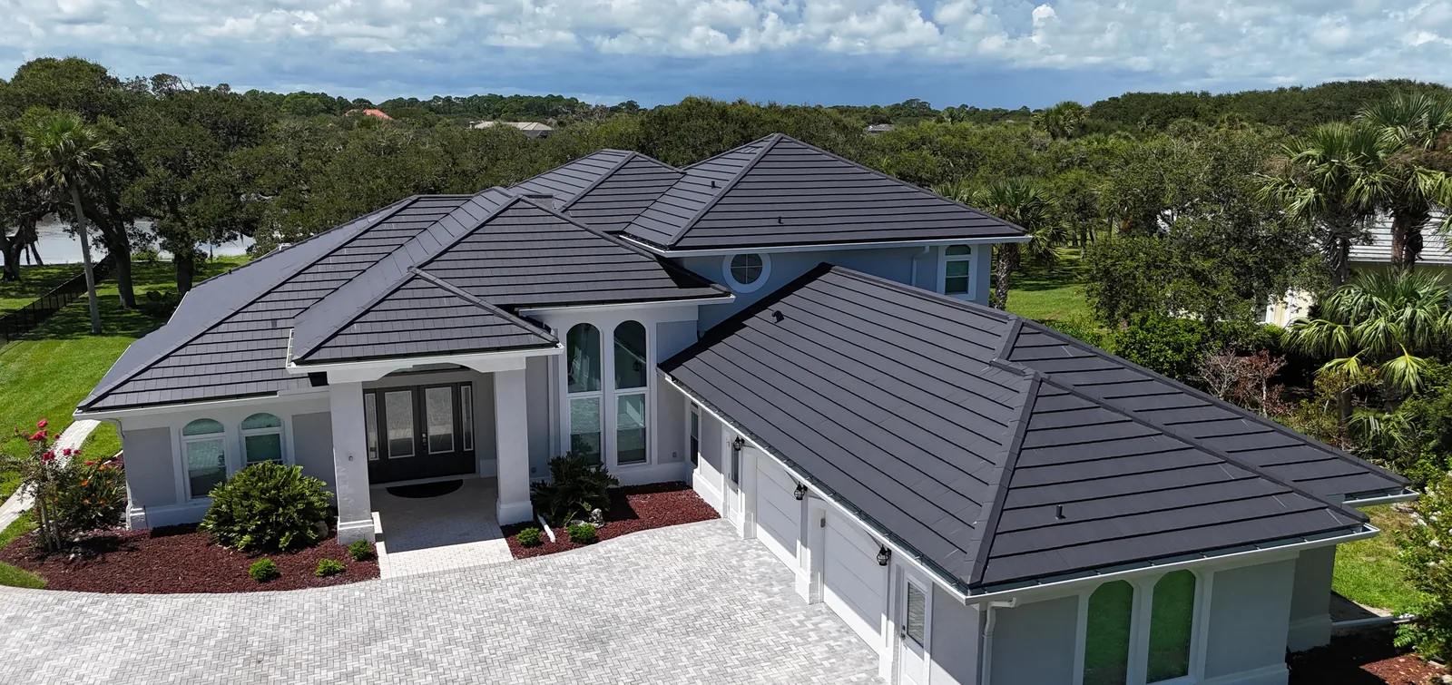 Dark flat-profile clay roof on a large estate home