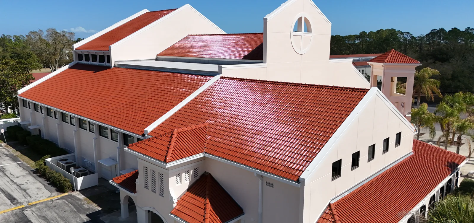 Red barrel clay tile roof across a large Mediterranean-style building